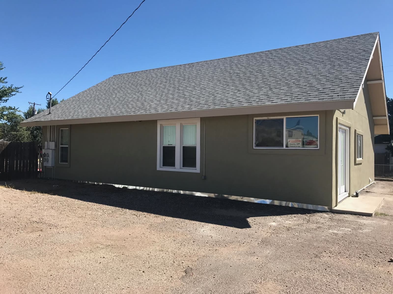 Sage-green stucco transformation, Confident Coatings office