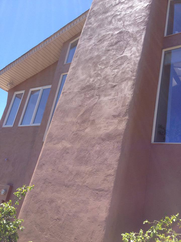 Adobe-terracotta stucco close-up after a Confident Coatings repaint